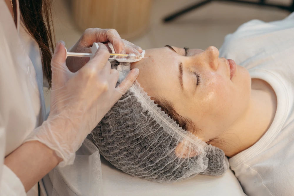 Forehead injection during a med spa Xeomin session.